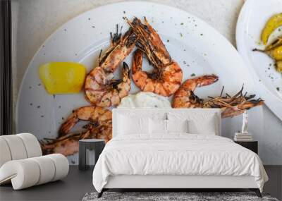 Grilled shrimps with yoghurt tzatziki sauce, lemon and herbs on white plate for a dinner - mediterranean greek cusine Wall mural