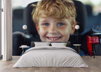  Happy young boy demonstrating safe travel concept in a car safety seat Wall mural