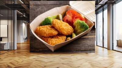 New fast food items including chicken strips, and fries on a platter with dipping sauces. Perfect for a casual meal or party snack. Wall mural