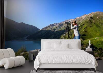 Tourist woman at the mountains at sunrise Wall mural