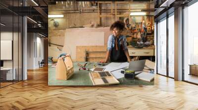 Afro american woman craftswoman working in her workshop

 Wall mural