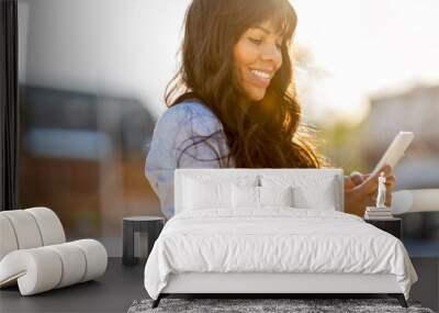 Attractive young woman using smartphone in the city
 Wall mural