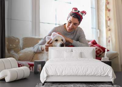 Boy and his dog enjoying Christmas together at home 
 Wall mural