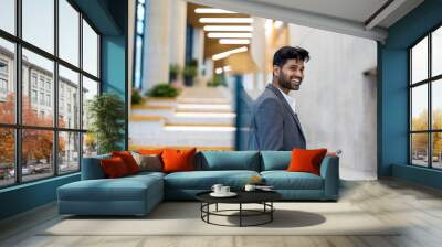 Confident young businessman in an office building
 Wall mural