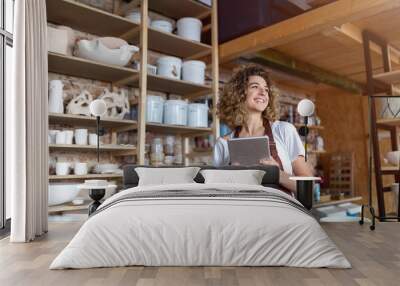 Craftswoman with tablet computer in art studio  Wall mural