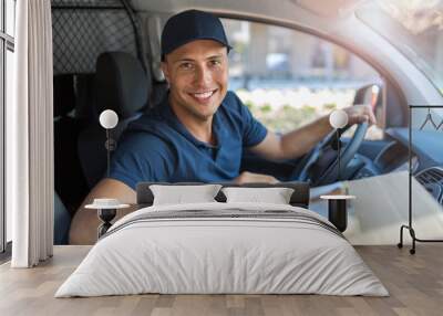 Delivery man sitting in a delivery van Wall mural