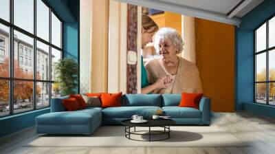 Female nurse taking care of a senior woman at home
 Wall mural