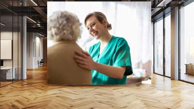 Friendly nurse supporting an elderly lady
 Wall mural