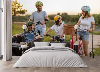 Happy family cycling together in the countryside
 Wall mural