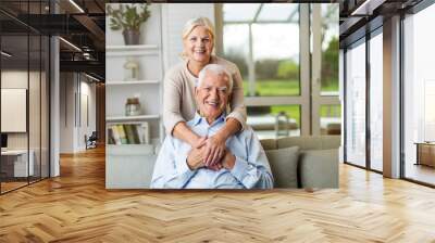 Happy senior couple at home Wall mural