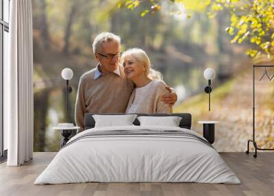 Happy senior couple in autumn park Wall mural