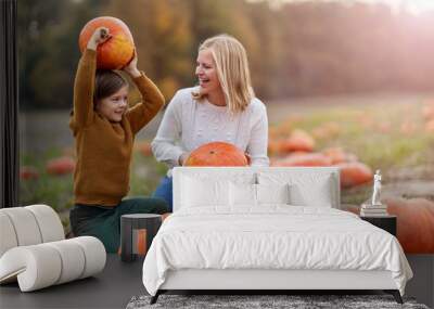 Mother and son in pumpkin patch field Wall mural