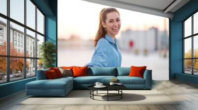 Portrait of a girl on a rooftop enjoying sunset Wall mural