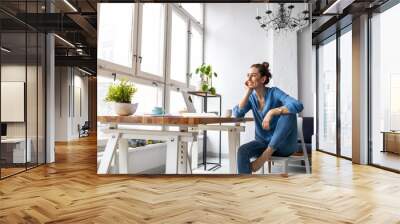 Portrait of a smiling creative woman in a modern loft space
 Wall mural