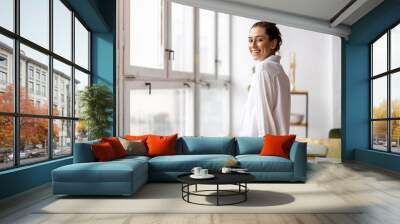 Portrait of a smiling creative woman in a modern loft space
 Wall mural