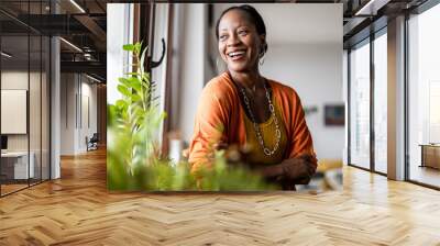 Portrait of a smiling mature woman standing in her apartment
 Wall mural