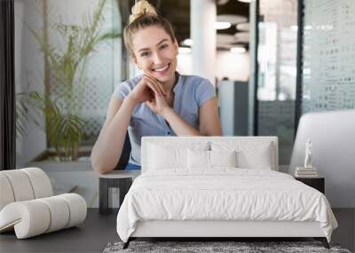 Portrait of a young business woman in an office Wall mural