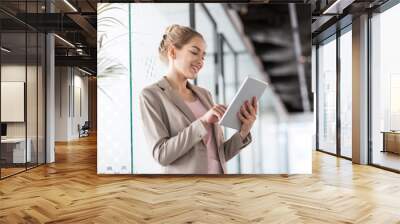 Portrait of a young business woman in an office Wall mural