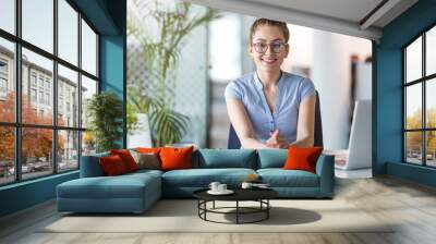 Portrait of a young business woman in an office Wall mural