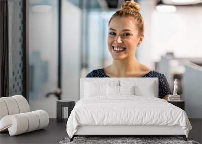 Portrait of an young businesswoman in a modern office 
 Wall mural