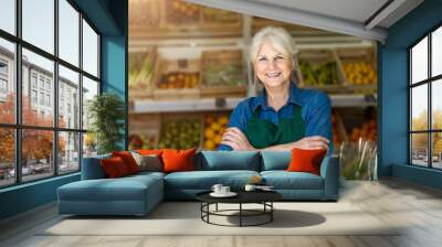 Portrait of confident owner with arms crossed standing in small grocery store Wall mural