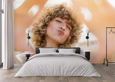 portrait of young woman with curly hair Wall mural