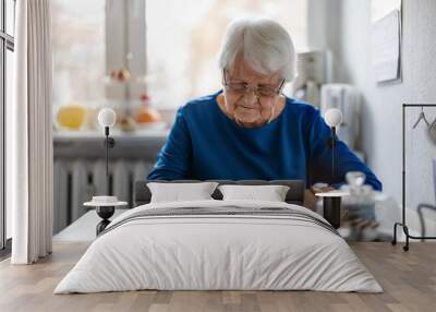 Senior woman filling out financial statements
 Wall mural