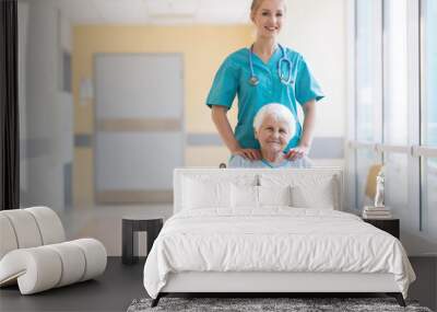 Senior woman in wheelchair with nurse in hospital Wall mural