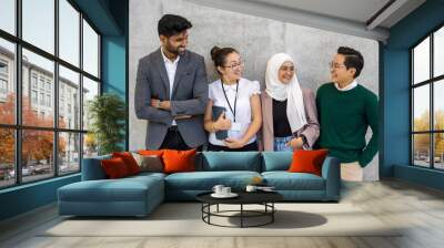 Shot of a small diverse group of businesspeople standing against a grey wall Wall mural