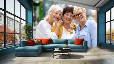 Three senior female friends having good time together
 Wall mural