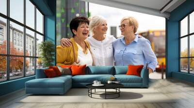 Three senior female friends having good time together
 Wall mural