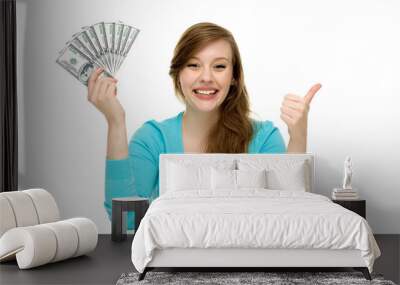 Woman holding money and showing thumbs up Wall mural