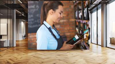 Woman working in wine shop 
 Wall mural