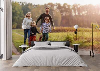 young family having fun outdoors Wall mural