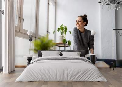 Young female freelancer working in loft office
 Wall mural