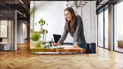 Young female freelancer working in loft office
 Wall mural