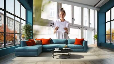 Young female freelancer working in loft office
 Wall mural