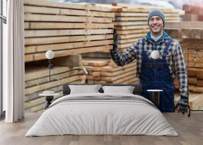 Young male worker in timber warehouse  Wall mural