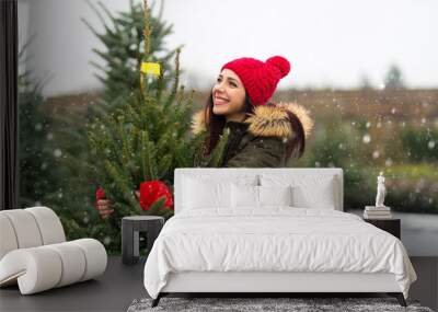 Young Woman Buying Christmas Tree
 Wall mural