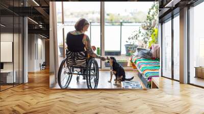 Young woman in wheelchair with her dog at home

 Wall mural