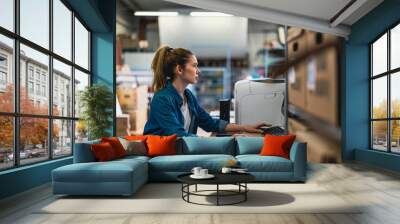 young woman working in an industrial place of work Wall mural