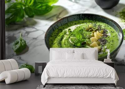 A bowl of green smoothie topped with chia seeds, almonds, and fresh basil. Wall mural