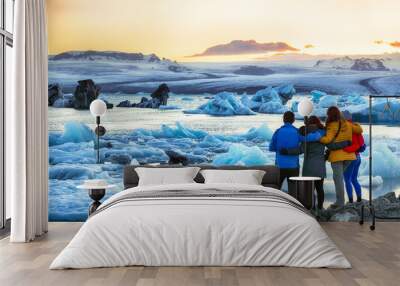 Group of tourist looking Beautifull landscape with floating icebergs in Jokulsarlon glacier lagoon at sunset Wall mural