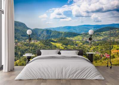 Stunning alpine landscape with green fields and Piatra Craiului mountains in Dambovicioara Commune Wall mural