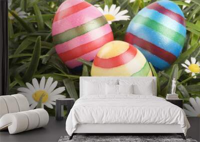 a group of colorful easter eggs lying on grass Wall mural