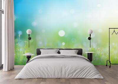 Beautiful sunny spring meadow with green grass and blue sky. Abstract background with light bokeh and space for text. Wall mural