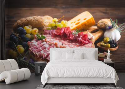 Cutting board with prosciutto, salami, ham, cheese, bread and olives Wall mural