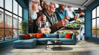 Group of senior friends enjoying healthy meal and conversation in restaurant Wall mural