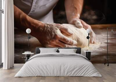 Male hands kneading dough on the wooden table, close-up Wall mural