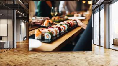 People enjoying sushi, oriental meal while dining out in the restaurant Wall mural